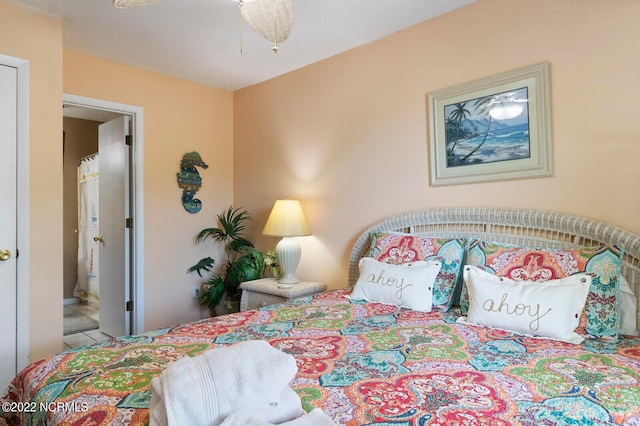 tiled bedroom with ensuite bathroom and ceiling fan