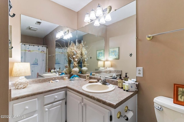 bathroom with toilet and vanity