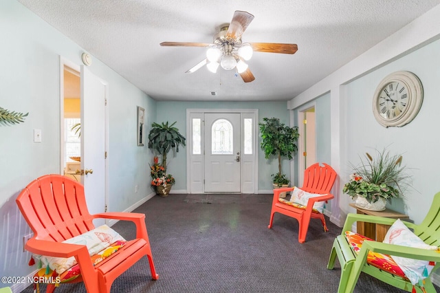 entryway with ceiling fan and a textured ceiling