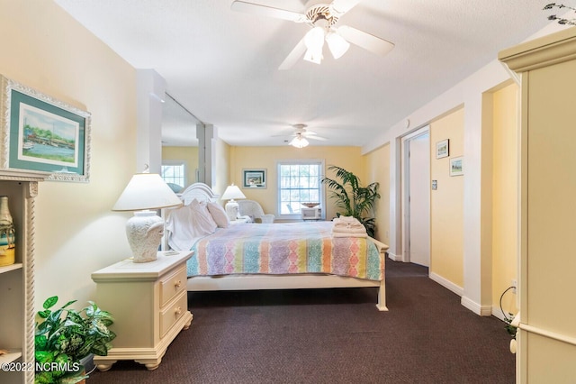 bedroom with dark colored carpet and ceiling fan