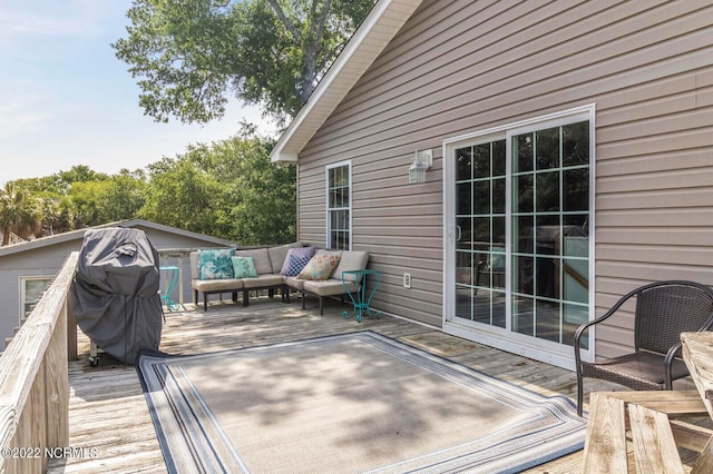 wooden deck with an outdoor living space