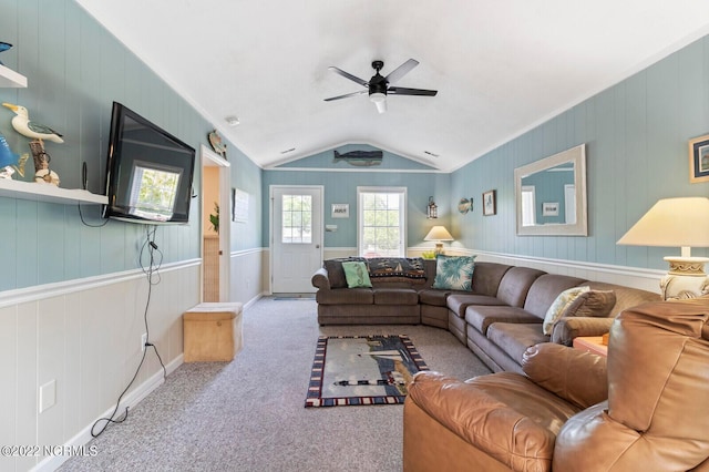 living room featuring ceiling fan, light carpet, and vaulted ceiling