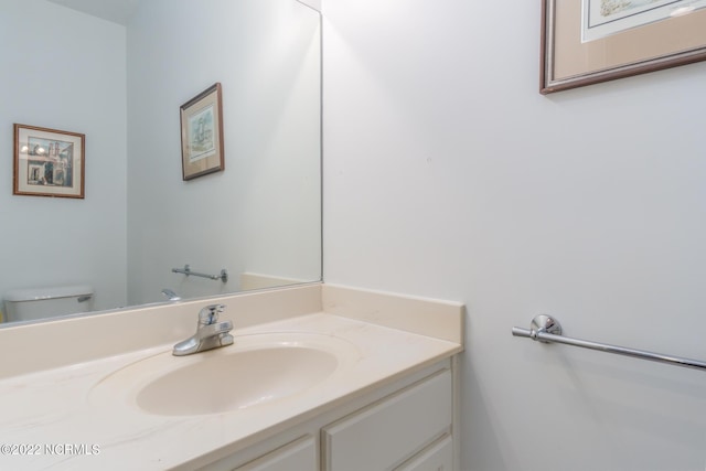 bathroom featuring toilet and large vanity