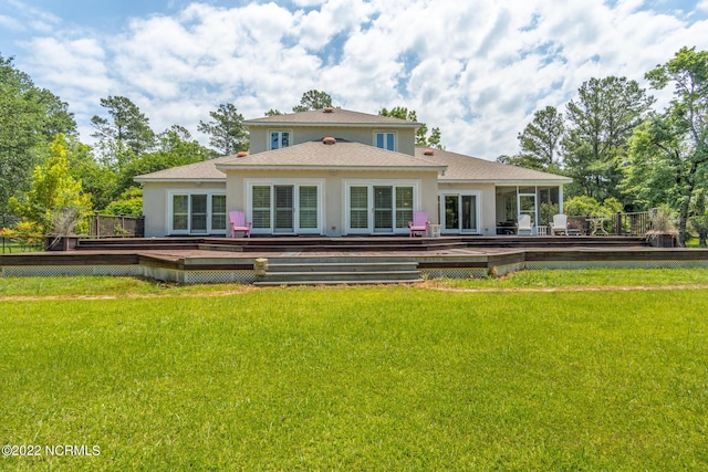 view of front facade with a front lawn and a wooden deck