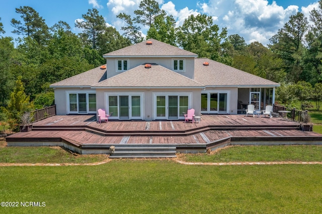 rear view of property with a yard and a deck