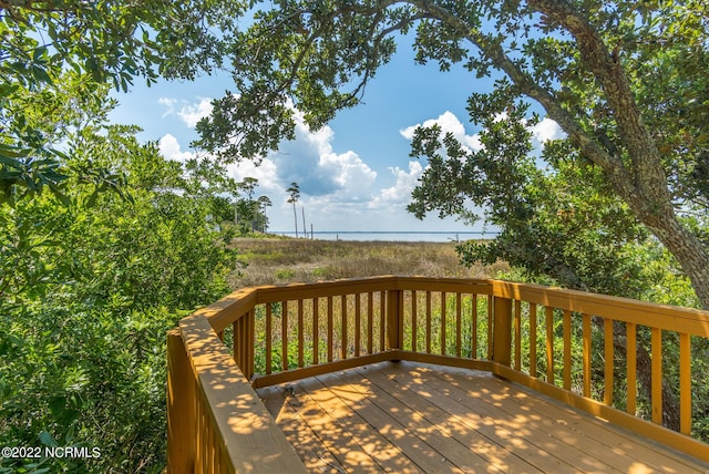 wooden terrace featuring a water view