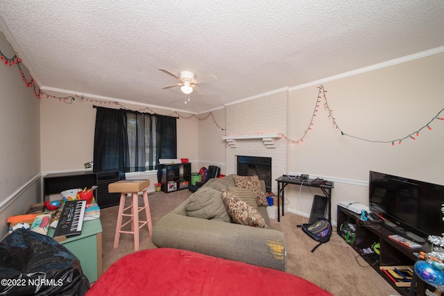 carpeted living room with ceiling fan, ornamental molding, a fireplace, and a textured ceiling