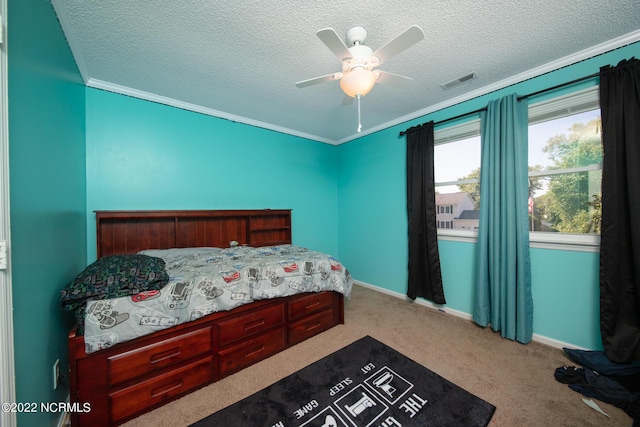 bedroom with ceiling fan, crown molding, light carpet, and a textured ceiling