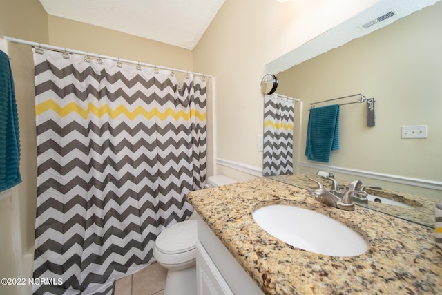 bathroom featuring tile flooring, toilet, and vanity