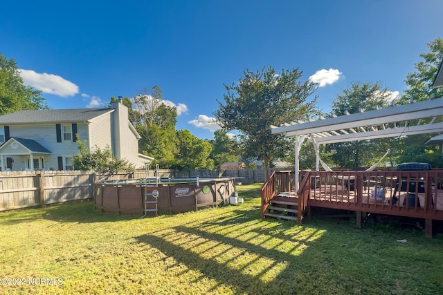 view of yard with a pergola and a pool side deck