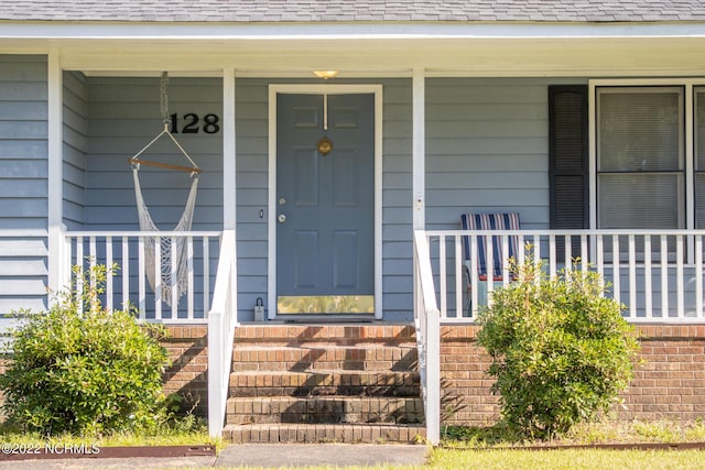 entrance to property featuring covered porch