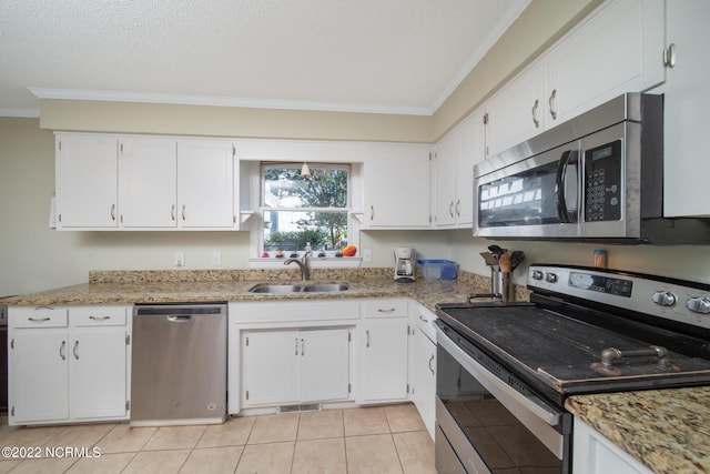 kitchen with appliances with stainless steel finishes, white cabinetry, and light stone counters