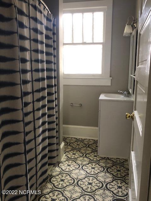 bathroom with tile floors and vanity