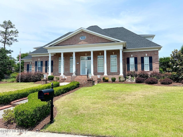 neoclassical home featuring a porch and a front lawn