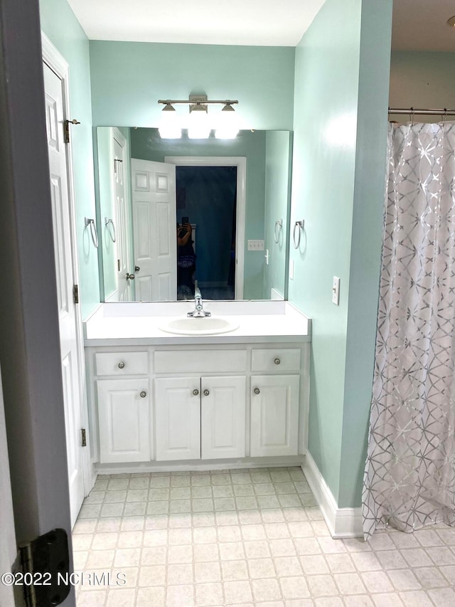 bathroom featuring vanity and tile floors