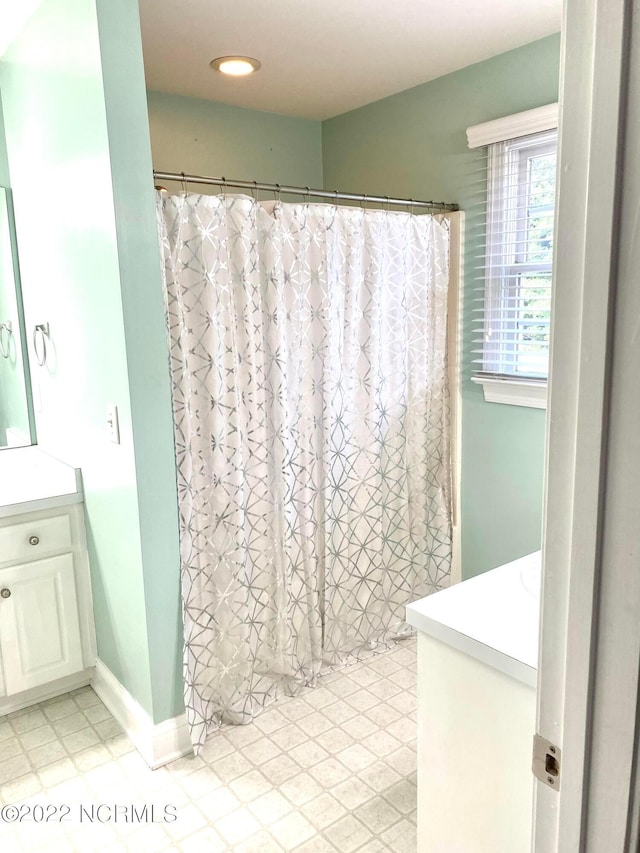 bathroom with tile flooring and vanity