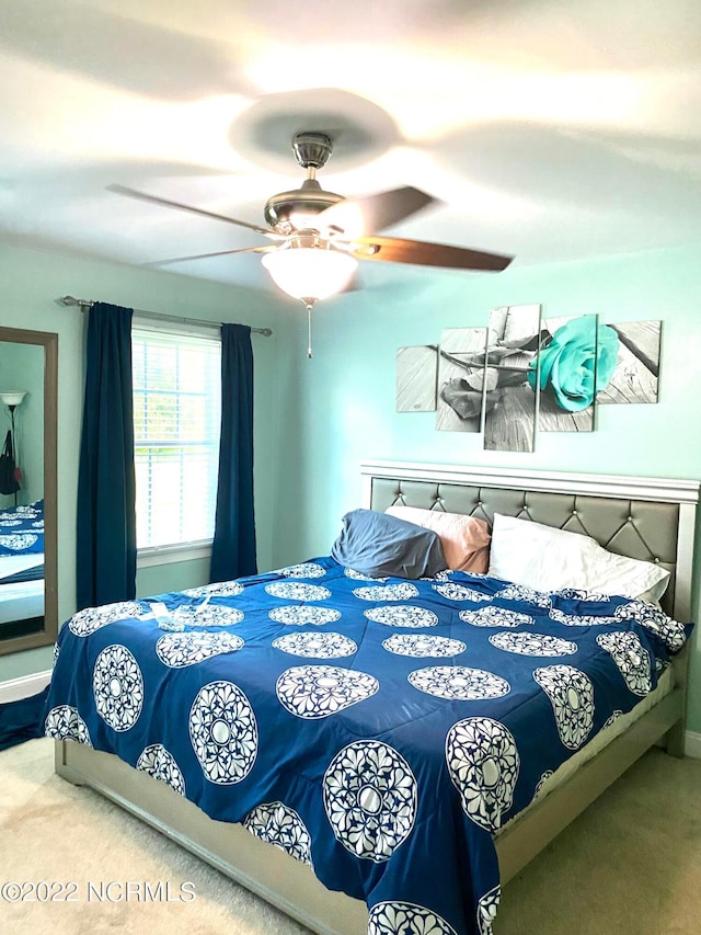 bedroom featuring light carpet and ceiling fan