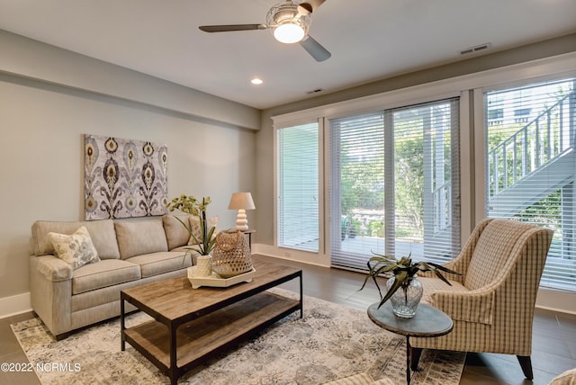 tiled living room featuring plenty of natural light and ceiling fan