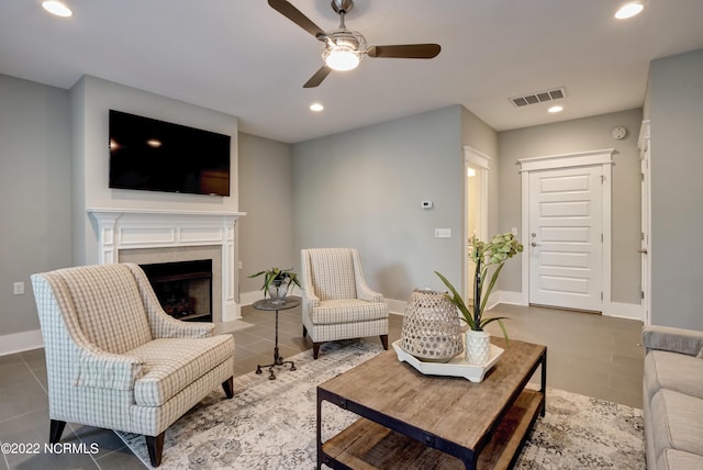 tiled living room with ceiling fan