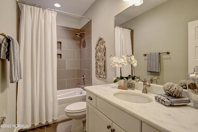 full bathroom with shower / bath combo, toilet, tile floors, and large vanity