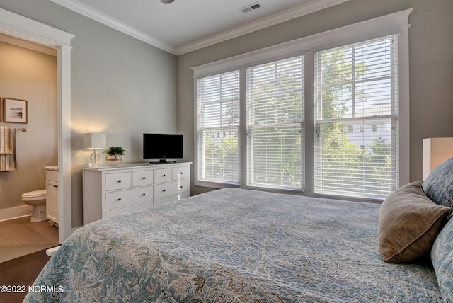 bedroom with crown molding, connected bathroom, hardwood / wood-style floors, and multiple windows