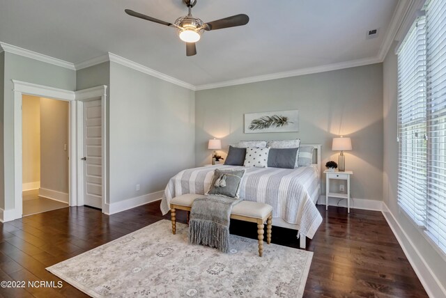 bedroom featuring multiple windows, crown molding, ceiling fan, and dark hardwood / wood-style flooring