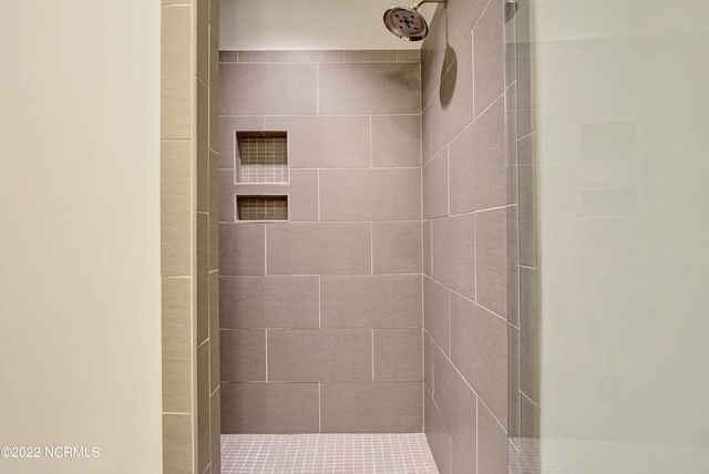 bathroom with a tile shower