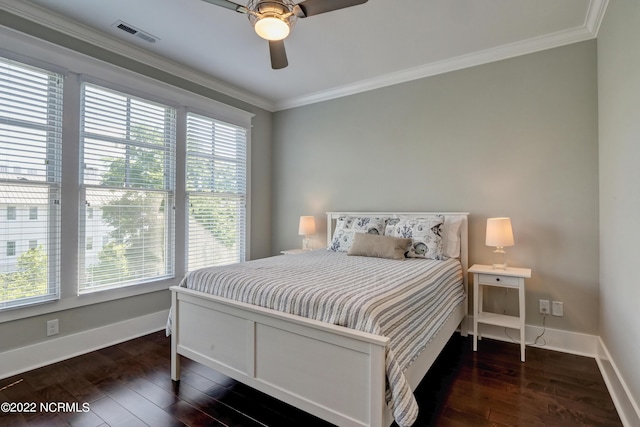 bedroom with crown molding, dark hardwood / wood-style floors, and ceiling fan