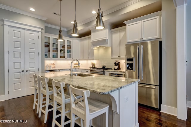 kitchen featuring decorative light fixtures, sink, stainless steel appliances, white cabinets, and dark hardwood / wood-style flooring