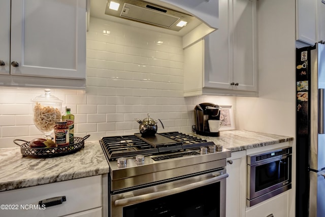 kitchen featuring backsplash, white cabinetry, and stainless steel appliances