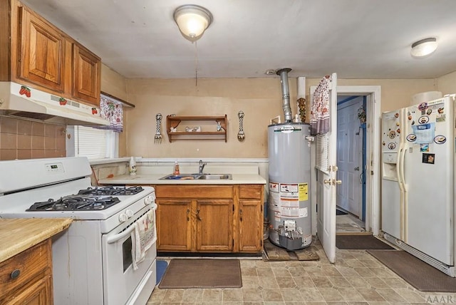 kitchen with light tile floors, white appliances, water heater, and sink