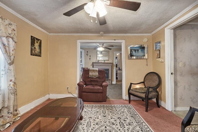 living area with light colored carpet, ceiling fan, a textured ceiling, and crown molding