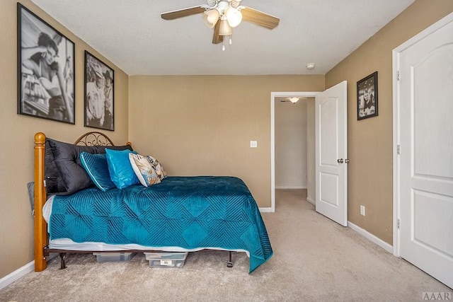 bedroom with light carpet and ceiling fan