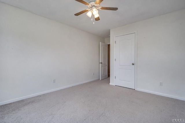 unfurnished room with light colored carpet and ceiling fan