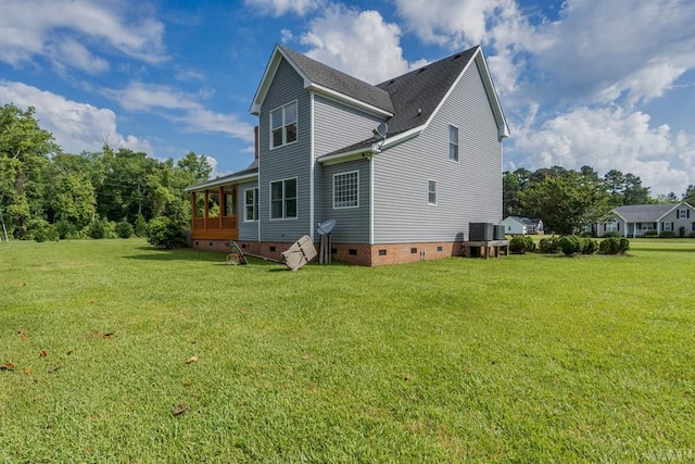 rear view of property featuring a yard