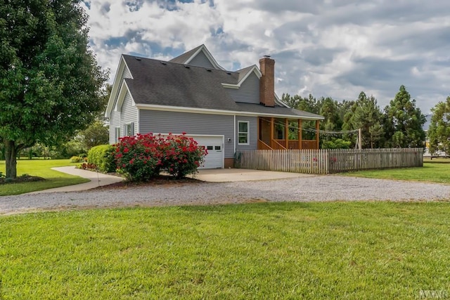 view of side of property featuring a yard and a garage