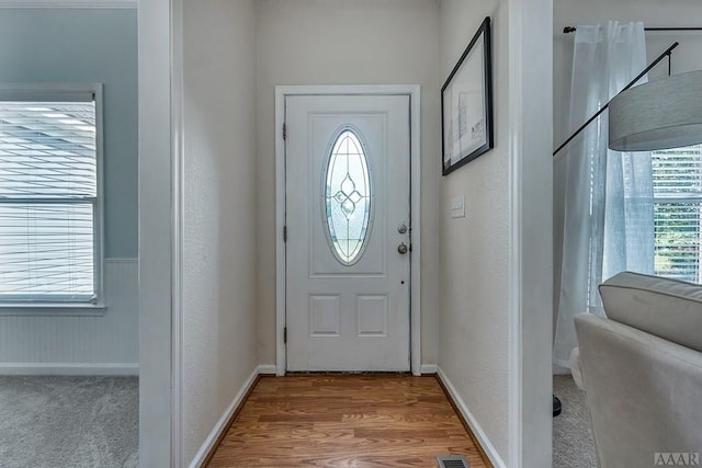 foyer entrance with light hardwood / wood-style flooring