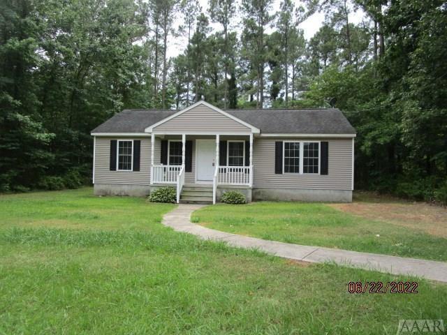 view of front of home featuring a front yard and covered porch