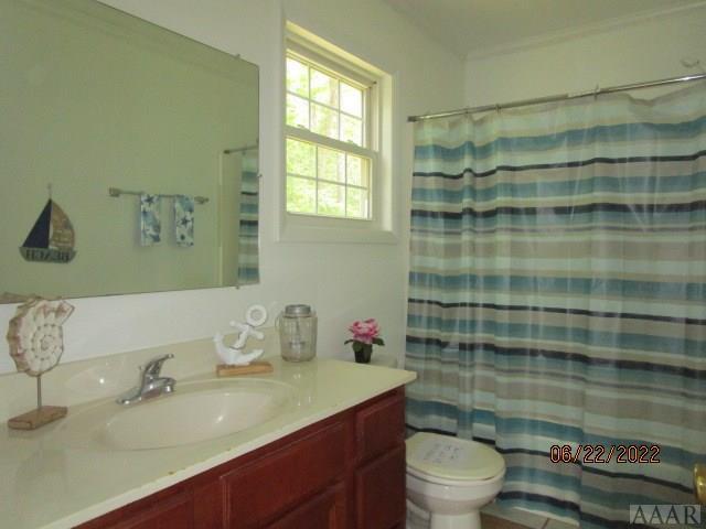 bathroom featuring toilet and vanity