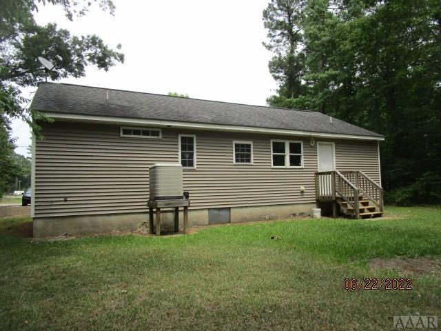 rear view of property with a lawn