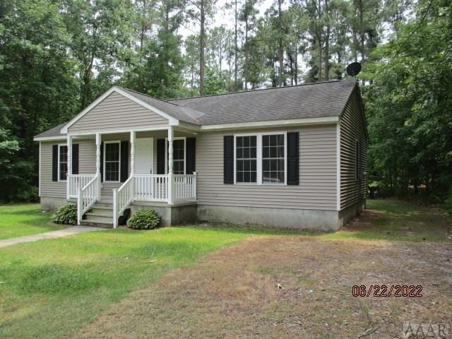 view of front of house with a porch and a front lawn