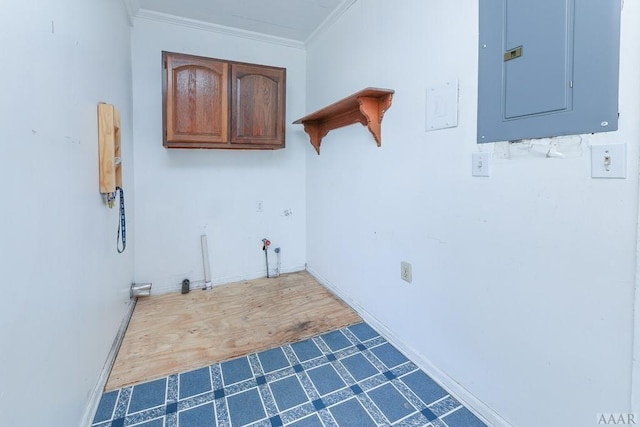 clothes washing area with crown molding and tile floors