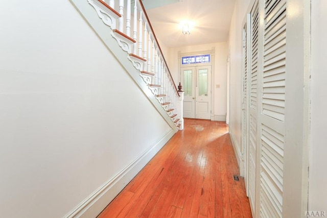 hallway featuring french doors and light hardwood / wood-style floors