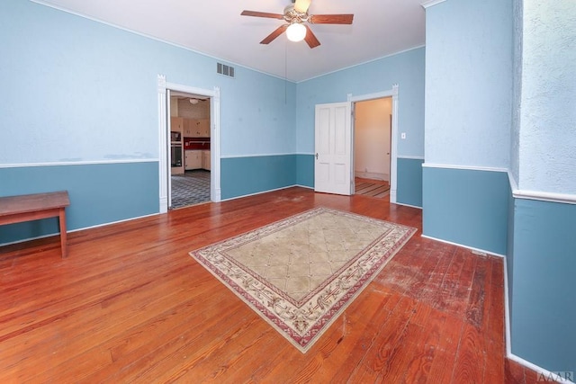 spare room featuring ceiling fan and dark wood-type flooring