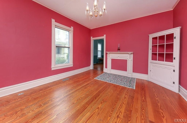 unfurnished room with light hardwood / wood-style flooring and an inviting chandelier