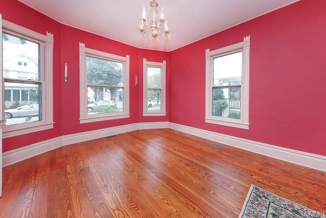 empty room featuring a chandelier and dark wood-type flooring