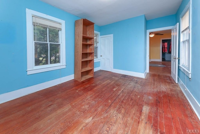 spare room featuring ceiling fan and dark wood-type flooring