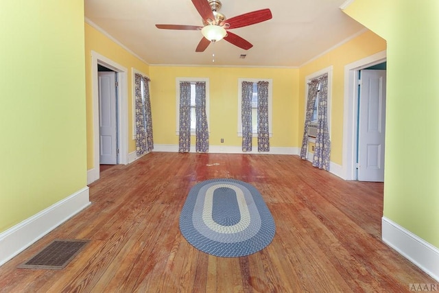 empty room featuring ceiling fan, ornamental molding, and light hardwood / wood-style flooring