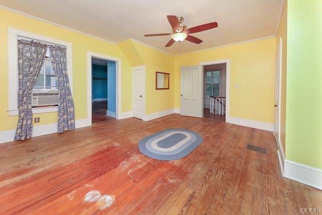 workout room with ceiling fan, crown molding, and dark hardwood / wood-style floors