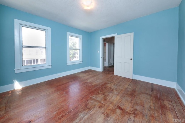 empty room featuring dark hardwood / wood-style flooring